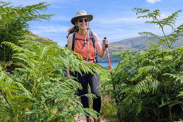 happy woman in field hiking